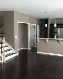 Home interior under construction with finished flooring and staircase