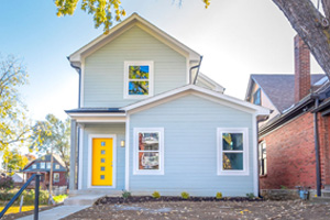 Longfellow infill home exterior with yellow front door